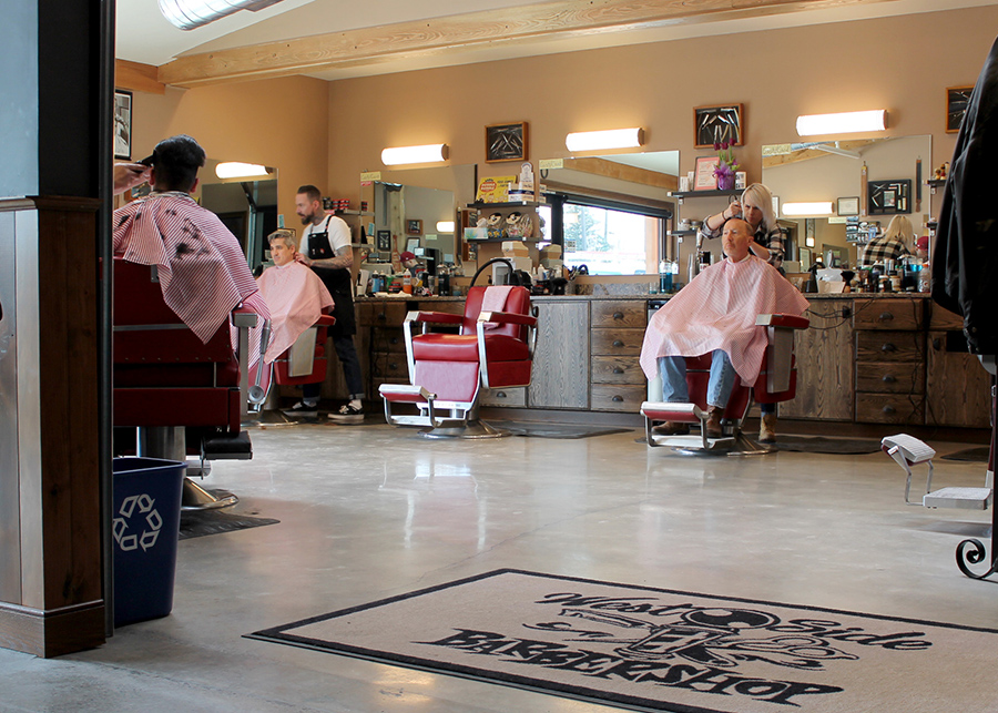 Patrons sit in old-fashioned barber’s chairs